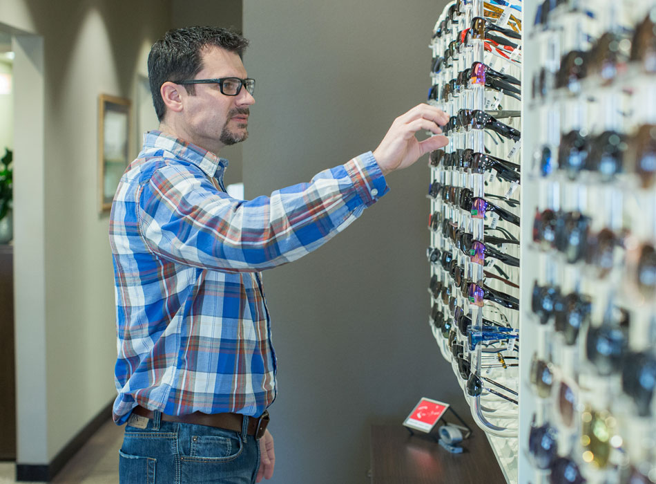 Man selecting eyeglasses at Rapid City Eye Care optical shop