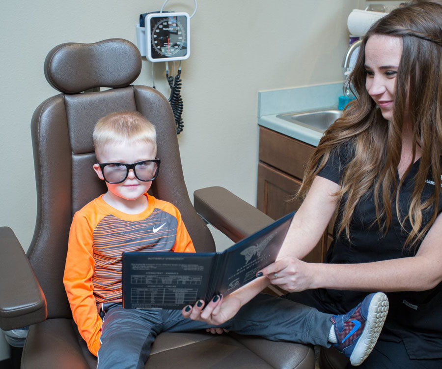 Kid trying glasses on to improve his vision