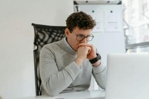 office worker staring at computer with blue light eyeglasses on