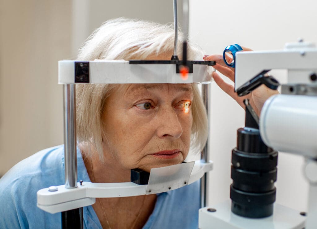 A senior woman gets her eyes examined for cataracts.