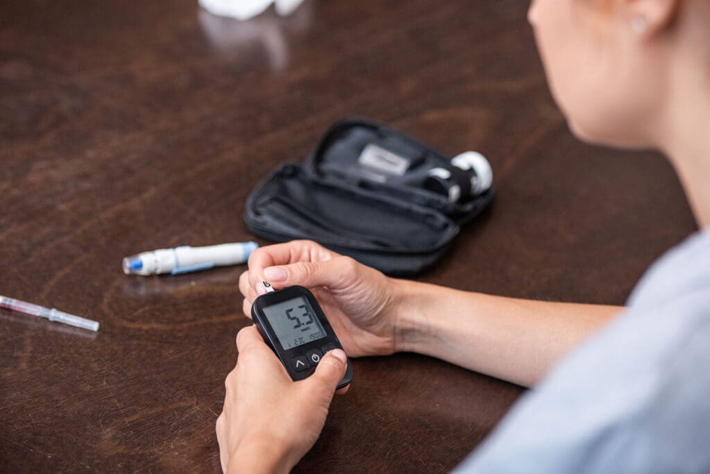 woman with diabetes tests her blood sugar