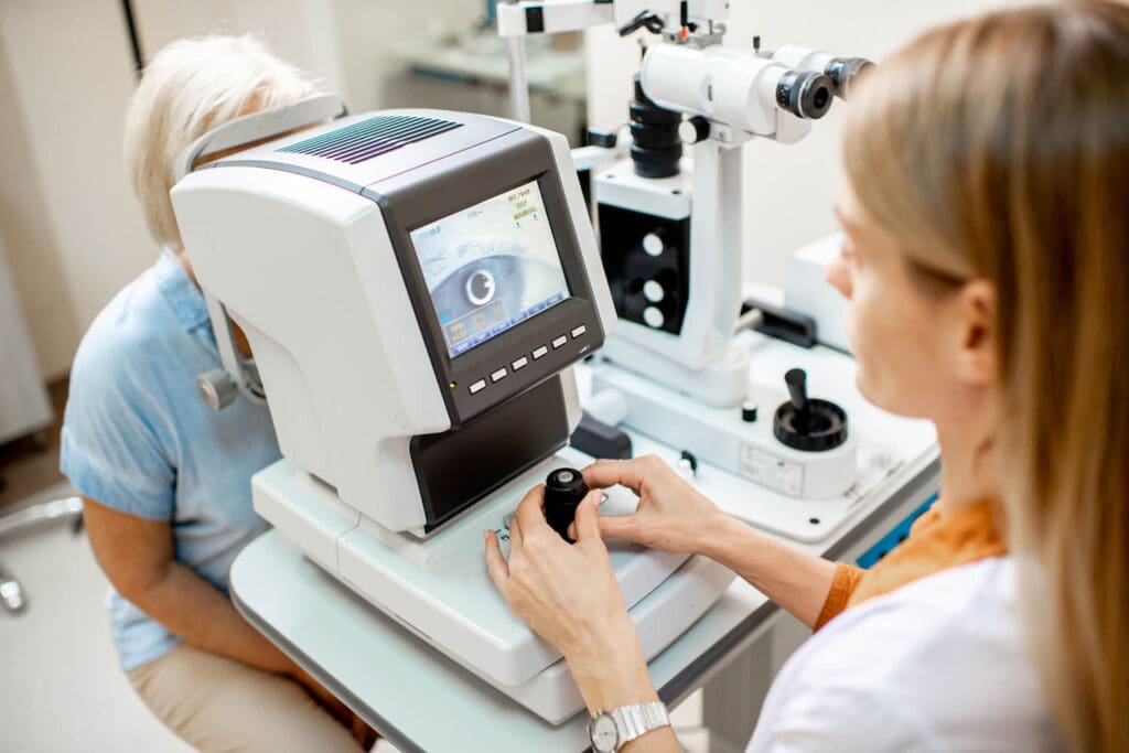 female ophthalmologist examines the eyes of an elderly female patient with diabetes.