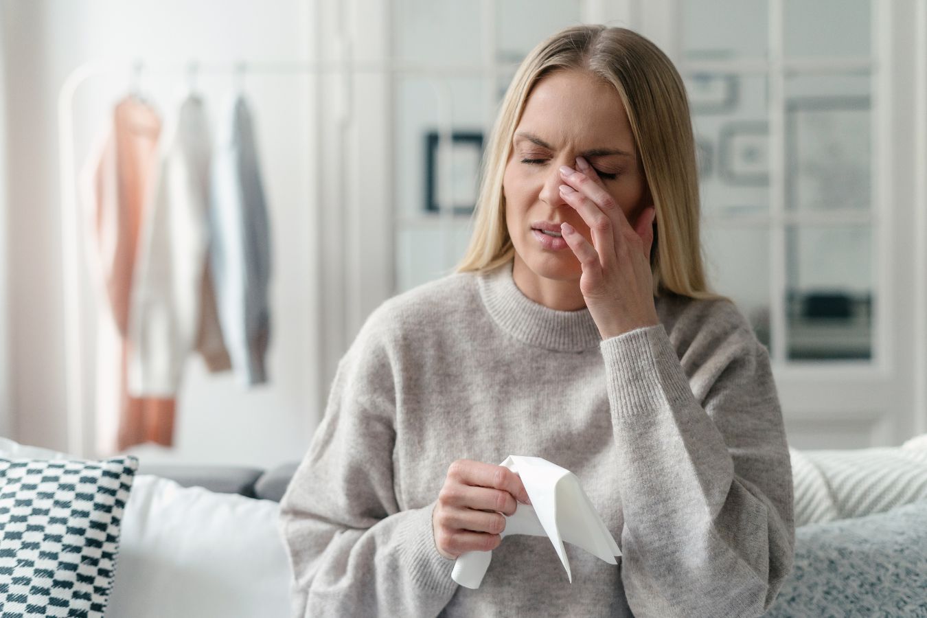 Woman holding tissue to her face due to dry eye