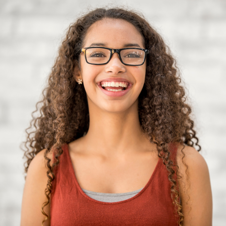 Teenage girl wearing rectangle glasses and smiling
