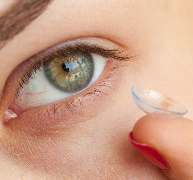 woman putting on contact lenses